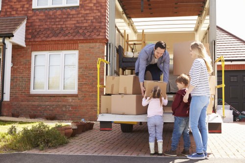 Professional movers loading household items for transport in Brook Green