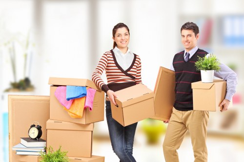 Packed moving boxes and furniture prepared for a Brook Green relocation